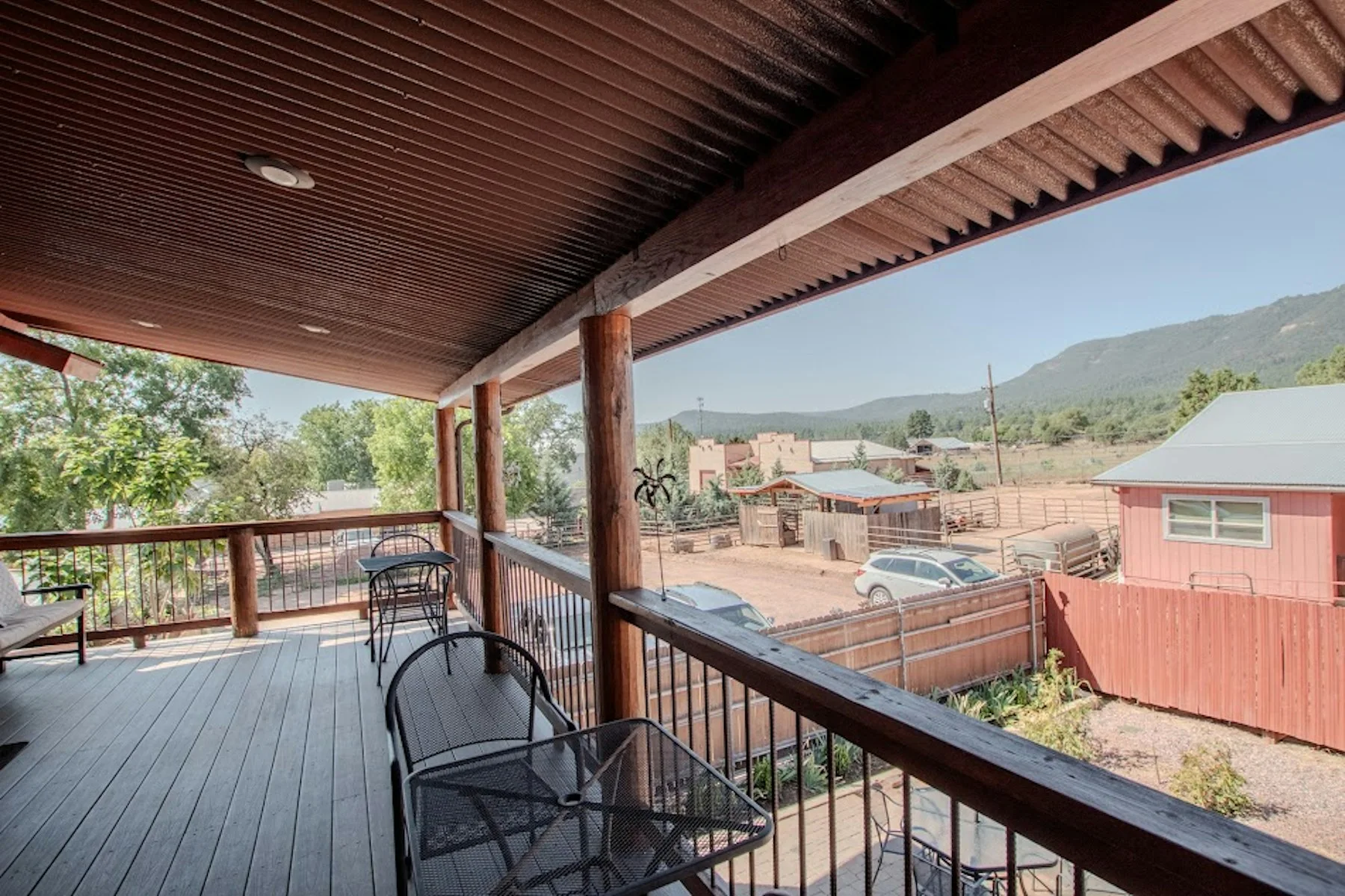 Covered upper deck with seating and views toward the mountains